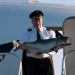 After landing, the captain brings out the lucky salmon.