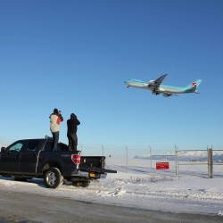 Spotters on the back of a Ford F150 taking photos of a Korean Air Cargo Boeing 747-8F.