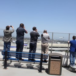 AvGeeks on top of the Theme Building at LAX taking photos of a Singapore Airlines Airbus A380.