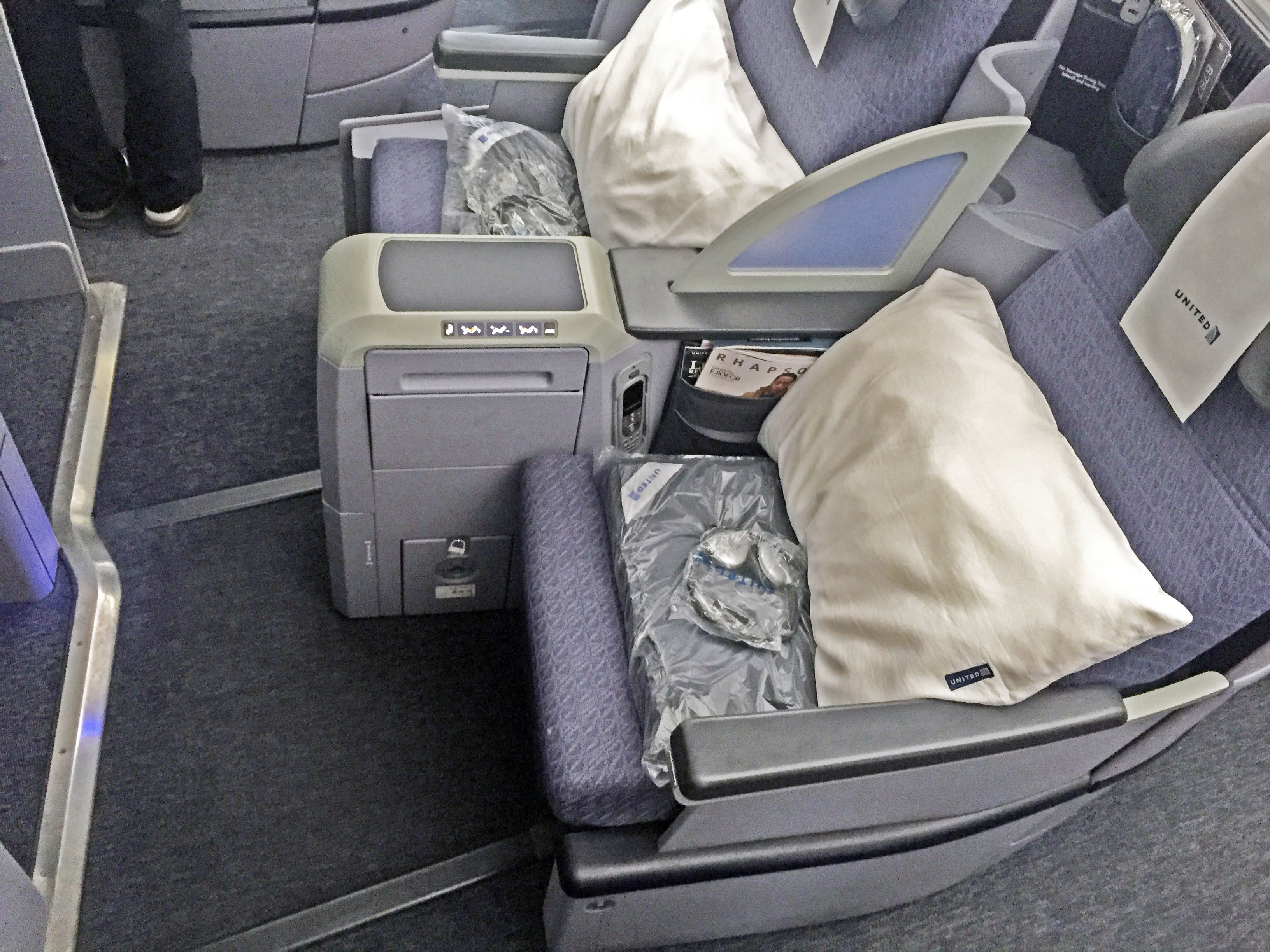 What is the difference between United Airlines first-class and economy seating?