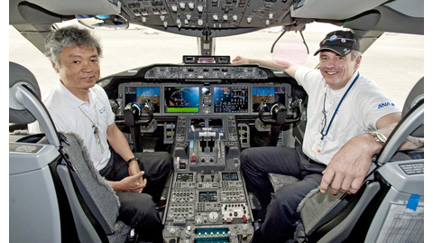 Capt. Ishii and Capt. Carriker relax in the flight deck between missions. From Boeing.