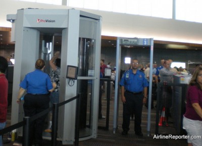 ou can see a woman being scanned. The TSA agent who yelled at me is stating in the metal detector.