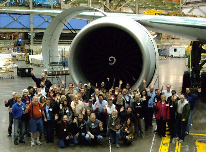 The group of Aviation Geek Fest geeks in front of a GE90 engine on a brand new Boeing 777