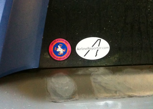 Airline Reporter sticker next to a Top Gun - Naval Fighting Weapons School - sticker. 