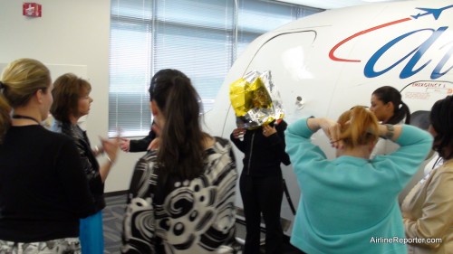 Current flight attendants putting on full head gear to use while putting out a fire.