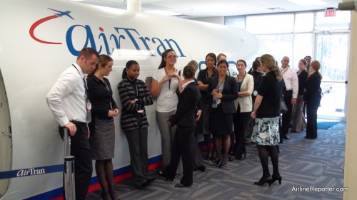 The Newbie Flight Attendants wait outside the mock Boeing 717 to be boarded for their fake flight to no where.