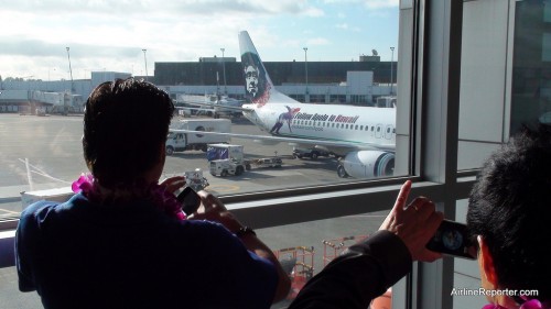 Apolo Ohno taking a photo of his image on an Alaska Airline's Boeing 737...how surreal