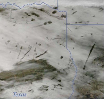 Photo from NASA's Terra satellite in 2007, showing a cloud bank riddled with canals and hole punches. State boundaries are shown in blue.