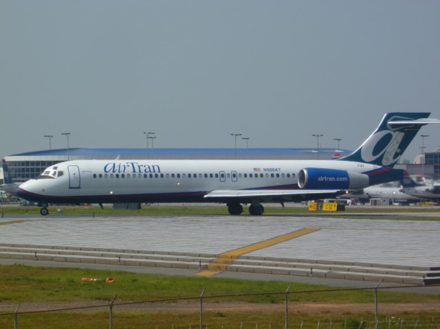 Mad Dog Wannabe:  An AirTran Boeing 717 taxis onto Runway 18L at Charlotte Douglas International Airport.