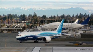 Boeing 787 Dreamliner ZA001 during its taxi testing with Dreamlifter in the background.