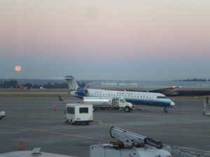 What a beautiful morning to fly. United Express (with white nose - N708SK) CRJ-700 with a United Boeing 757 and moon in the background at SEA.