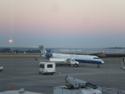 What a beautiful morning to fly. United Express (with white nose - N708SK) CRJ-700 with a United Boeing 757 and moon in the background at SEA.