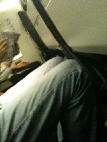 Colby on a recently flight. Imagine if the seat were reclined. He can't even make the tray table go flat.