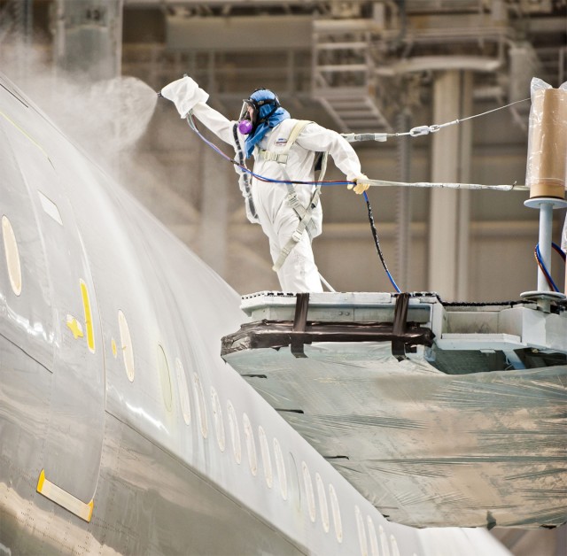 Boeing painter Bill Pearson applies chrome-free primer to the 777-300ER that was delivered to Air New Zealand in November 2011. Photo from Boeing.