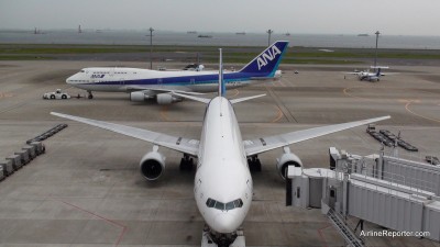 ANA Boeing 747, 777, 737 and Q400 with ships in the background.
