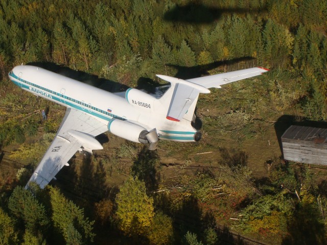 Alrosa Mirny Air Enterprise Tupolev TU-154M (RA-85684) sits in the mud outside a small, closed, regional airport.