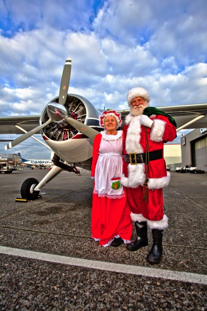 The Clauses pose before their Beaver floatplane before taking off. (Photo by Jeremy Dwyer-Lindgren)