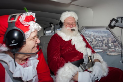 Santa and Mrs. Claus fly past the Seattle Space Needle. (Photo by John Harrell)