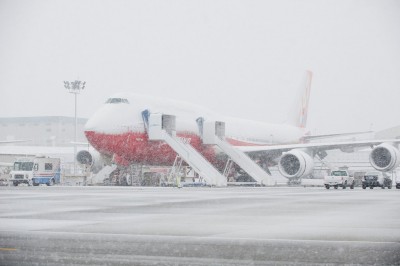747-8I In Snow on Flightline K65171 The first Boeing 747-8 Intercontinental (N6067E)outside in the snow with its orange livery.
