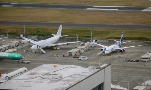 The first Boeing 747-8 Intercontinental (A7-HHE) sits next to ANA's first Boeing 787 Dreamliner (JA801A) in September 2011. Photo by Jon Ostrower.