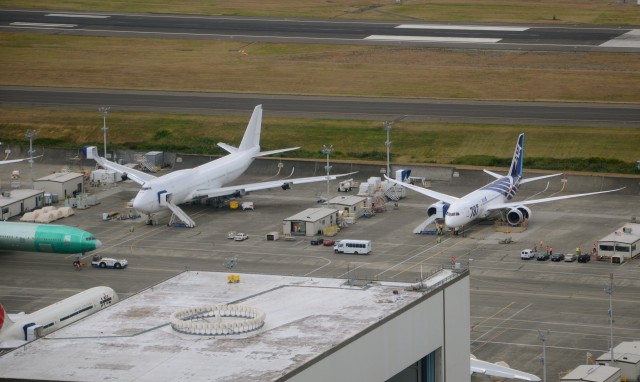 The first Boeing 747-8 Intercontinental (A7-HHE) sits next to ANA's first Boeing 787 Dreamliner (JA801A) in September 2011. Photo by Jon Ostrower. 