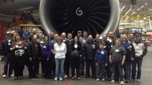 A group from Aviation Geek Fest pose in front of a 777 GE90 engine on the Boeing factory floor. Photo by Boeing.