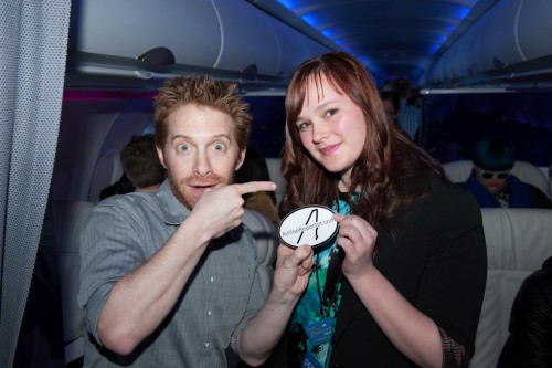 Seth Green and Brandi Bell pose with an AirlineReporter.com sticker on Virgin America's inaugural LAX-PHL flight. CLICK FOR LARGER.