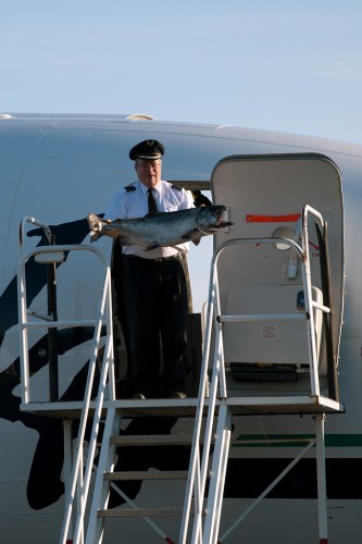 After landing, the captain brings out the lucky salmon.