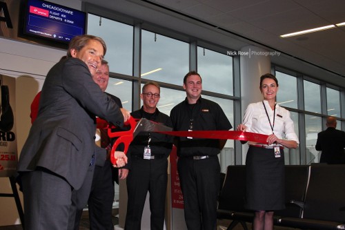 Virgin America's CEO David Cush cuts the ribbon.