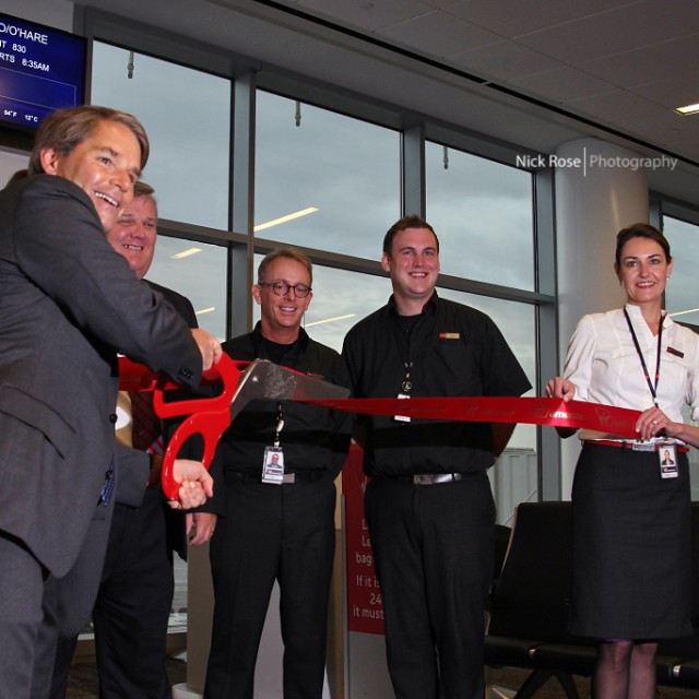 Virgin America's CEO David Cush cuts the ribbon.