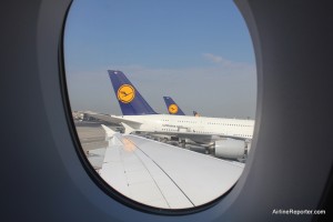 outwindow There were three Lufthansa Airbus A380s waiting at Frankfurt when we left.