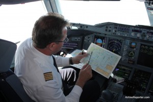 pilot Visiting the flight deck while in flight was amazing. I am being shown where we currently are with an old-school map.