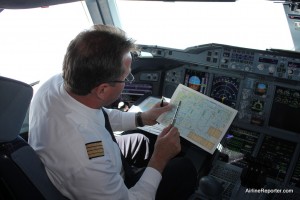 Visiting the flight deck while in flight was amazing. I am being shown where we currently are with an old-school map.
