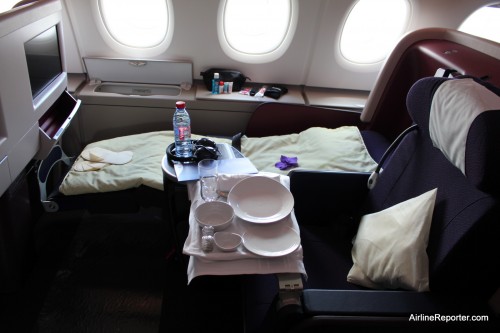A Business Class seats in sleaping and eating positions.