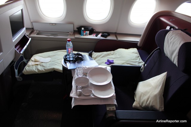 A Business Class seats in sleaping and eating positions. 