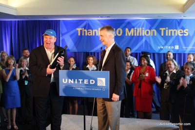 UATom United uber frequent flyer, Tom Stuker, gets a custom labeled bottle of wine from United President and CEO Jeff Smisek.