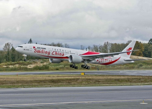 HI RES IMAGE (click for larger). Air China"s new 777-300ER adorned with the distinctive Smiling Faces" livery takes-off from Paine Field Airport in Everett, Washington on October 30. Image from Boeing.