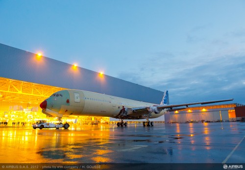 The structurally-complete no. 1 A350 XWB flight test aircraft is shown during its transfer at the Airbus final assembly line in Toulouse, France — moving from Station 40 in the main assembly hall to the adjacent indoor ground test station (Station 30) . Image from Airbus. Click for larger.