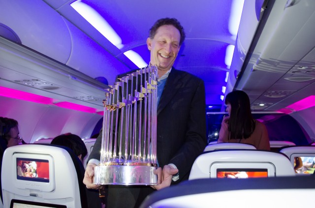 Giants President/CEO Larry Baer walks down the aisle with the World Series Trophy
