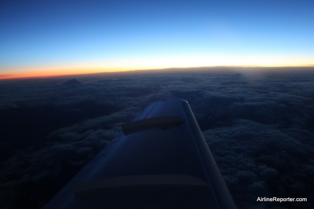 Mount Rainier and Adams popping above the clouds shortly after take off.