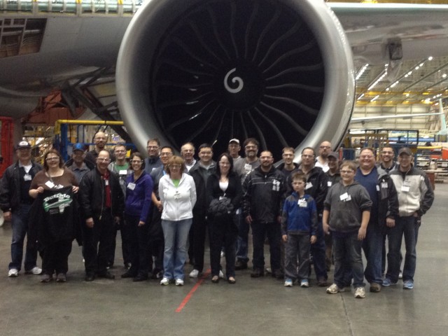 A group from Aviation Geek Fest pose in front of a 777 GE90 engine on the Boeing factory floor. Photo by Boeing.