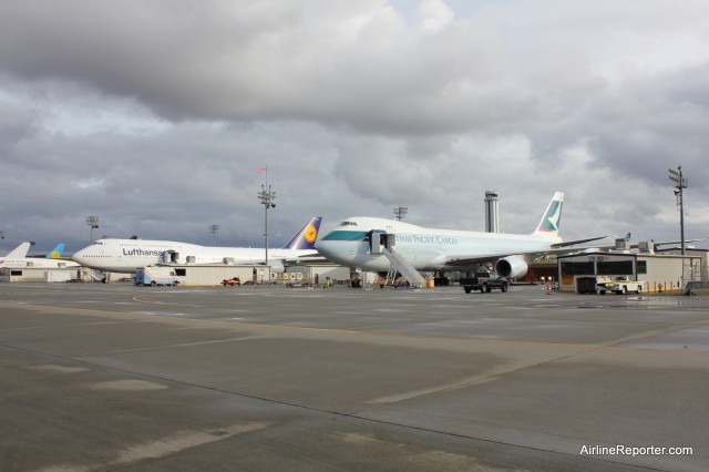 Cathay Pacific Boeing 747-8F sits next to Lufthansa's Boeing 747-8 Intercontinental.
