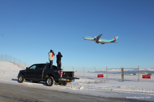 Spotters on the back of a Ford F150 taking photos of a Korean Air Cargo Boeing 747-8F.