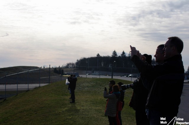 People lined up on the mounds outside Future of Flight, to take photos of an aircraft departing.  Photo by Malcolm Muir / AirlineReporter.com. 