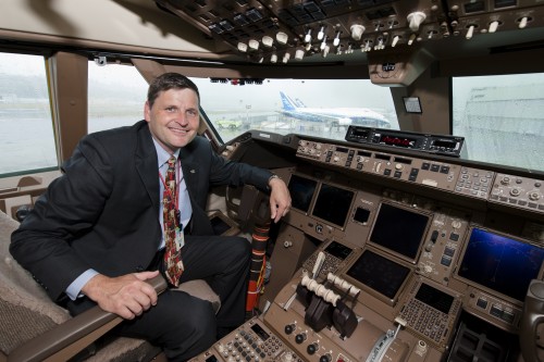 Captain Steve Taylor at the controls of a 747-8I before flight. Image from Boeing.