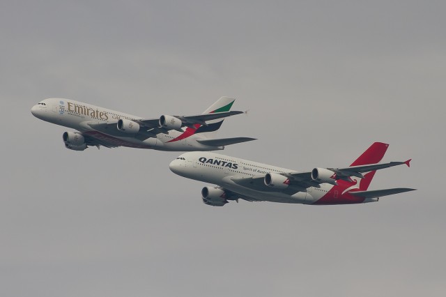 An Emirates A380 flies High and to the Right of the Qantas A380 - Photo: Bernard Proctor
