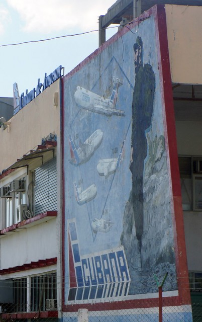 Fidel Castro, in full military garb, is painted posing with Cubana’s old Russian fleet in this mural on a wall of the airline’s maintenance base at HAV. Photo by Chris Sloan. 