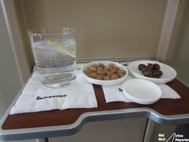 Pre Departure Beverage of Choice with some Toasted Almonds & Marinated Olives, what a way to start a flight!  - Photo: Mal Muir - AirlineReporter.com