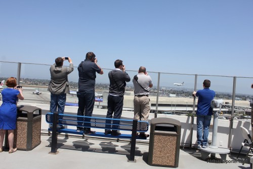 AvGeeks on top of the Theme Building at LAX taking photos of a Singapore Airlines Airbus A380.