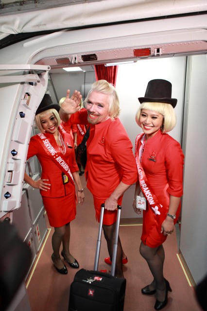 Sir Richard Branson Poses at the Entrance to the A330 with two of the Air Asia Cabin Crew - Photo: Adam Lee, Air Asia